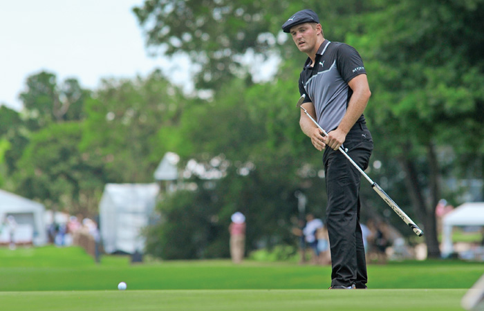 Bryson DeChambeau watches putt